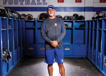 Apollo Football Coach Phil Hawkins standing in locker room