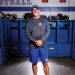 Apollo Football Coach Phil Hawkins standing in locker room