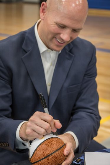 Signing a basketball