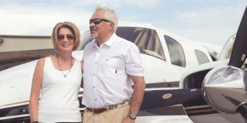 Susan and Ray Assmar in front of their Beechcraft Duke airplane
