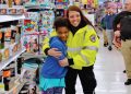 Girl and EMT Worker during Shop With a Cop