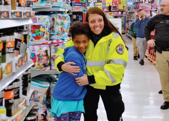 Girl and EMT Worker during Shop With a Cop