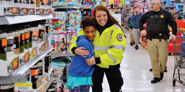 Girl and EMT Worker during Shop With a Cop