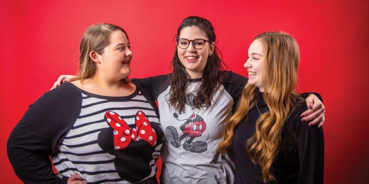 Eva Cash, Jessica Gillum, and Joy Beth Whitmer pose together wearing Minnie Mouse ears