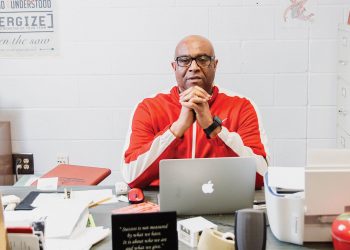 Teacher and coach Rod Drake sitting at his desk