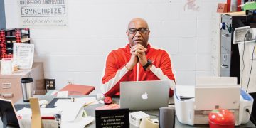 Teacher and coach Rod Drake sitting at his desk