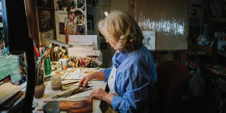 Artist Rhonda McEnroe working in her studio