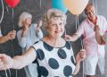 Elderly people holding balloons