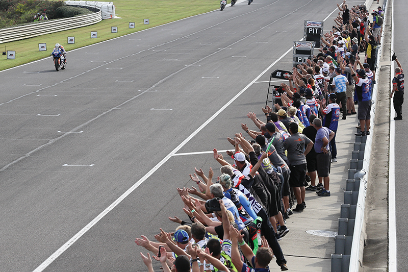 Fans cheering for racer Roger Lee Hayden on the racetrack