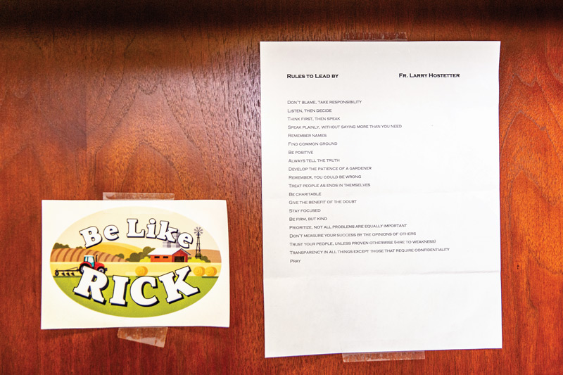 A "Rules to Lead By" guide and "Be Like Rick" sticker hang on her wall.