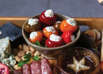 Closeup of stuffed peppadew peppers on a charcuterie board