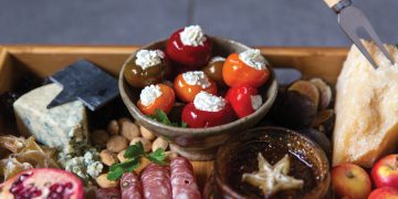 Closeup of stuffed peppadew peppers on a charcuterie board