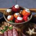 Closeup of stuffed peppadew peppers on a charcuterie board
