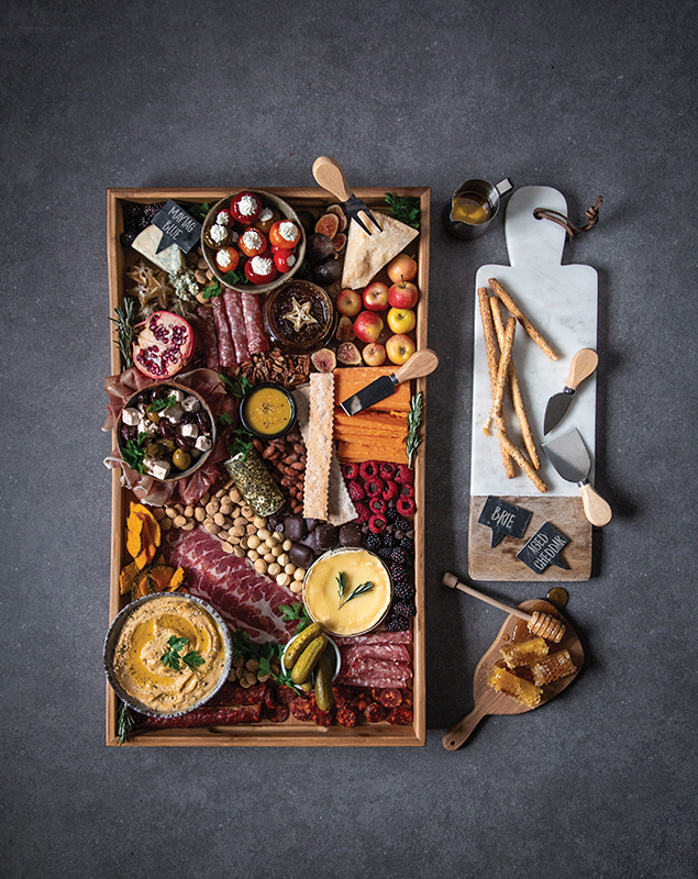 Overhead photo of Charcuterie and Cheese Board on gray stone background