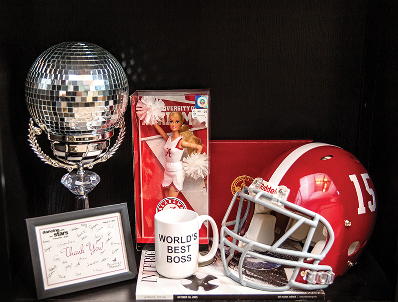 mirror ball, World's Best Boss coffee mug, and University of Alabama memorabilia