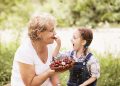 Woman and child eating strawberries.