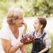 Woman and child eating strawberries.
