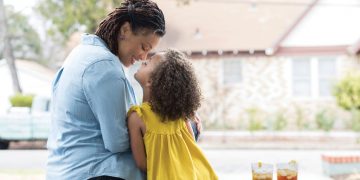 Mother and child sitting and drinking tea.