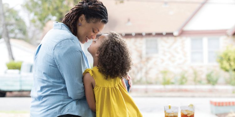 Mother and child sitting and drinking tea.