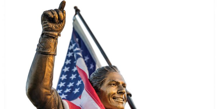 Nicky Hayden memorial statue with American flag.