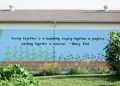 A quote by Henry Ford is painted on the side of a building at Century Christian Church.