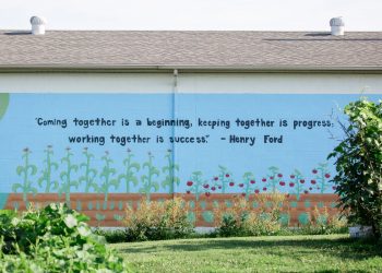 A quote by Henry Ford is painted on the side of a building at Century Christian Church.