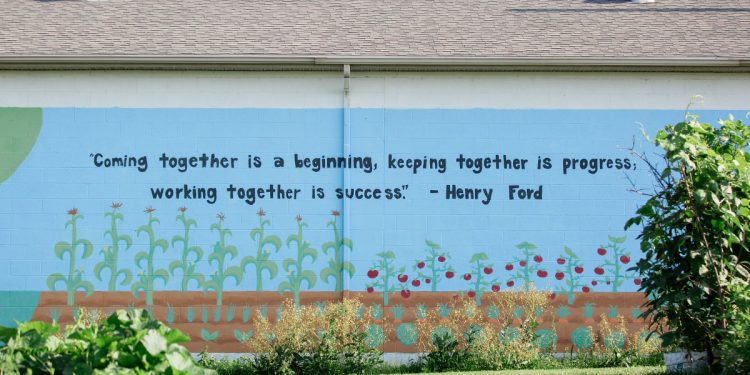 A quote by Henry Ford is painted on the side of a building at Century Christian Church.