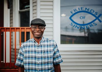 Garswa Matally, leader of the Genesis Men's program, stands smiling.