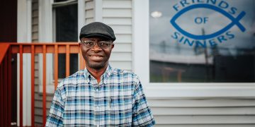 Garswa Matally, leader of the Genesis Men's program, stands smiling.