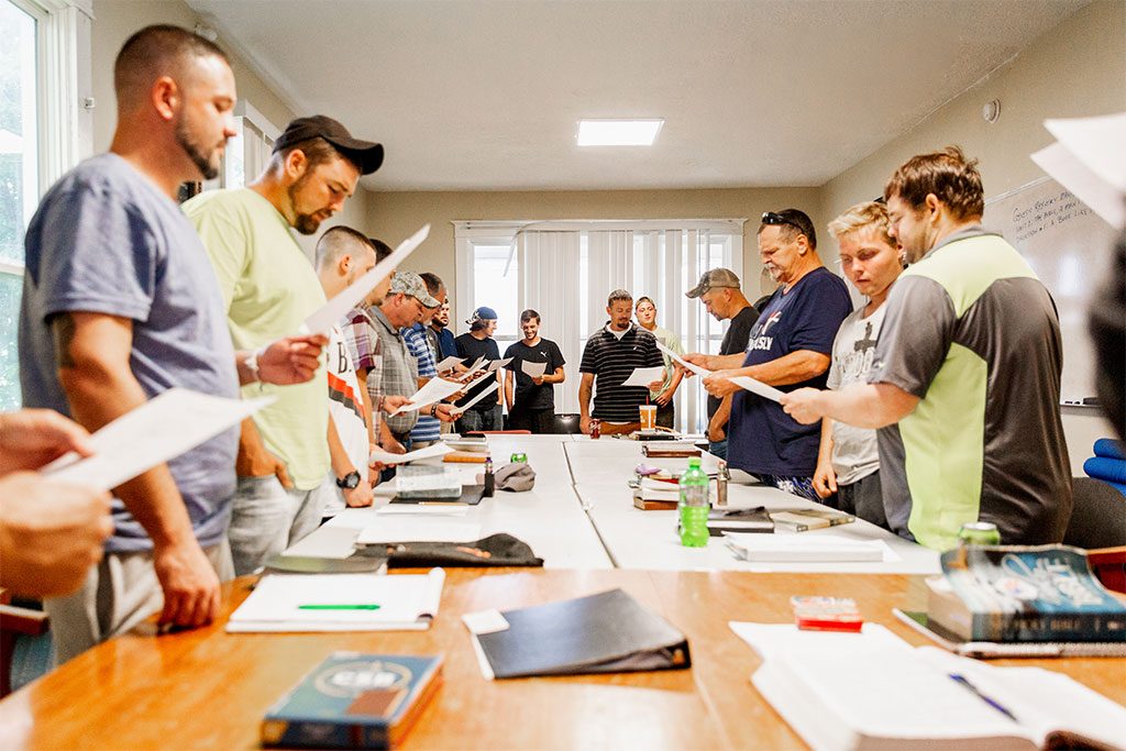 People gather around a table during one of the classes.