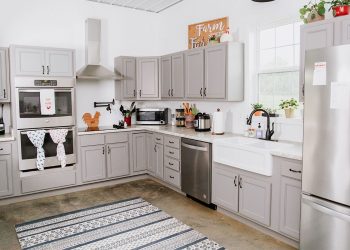 The "Fixer Upper" inspired kitchen uses gray cabinets and white walls.