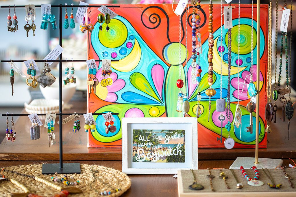 A display of brightly colored beads and gemstones hang in the store.