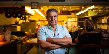 George Skiadis, owner of Famous Bistro, stands proud in front of his restaurant.