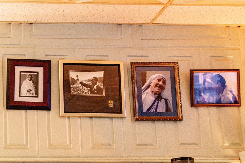 Images of Mahatma Gandhi, Dr. Martin Luther King Jr., and Mother Theresa hang in the restaurant.