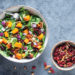 Overhead photo of autumn squash salad with side of walnuts and cranberries