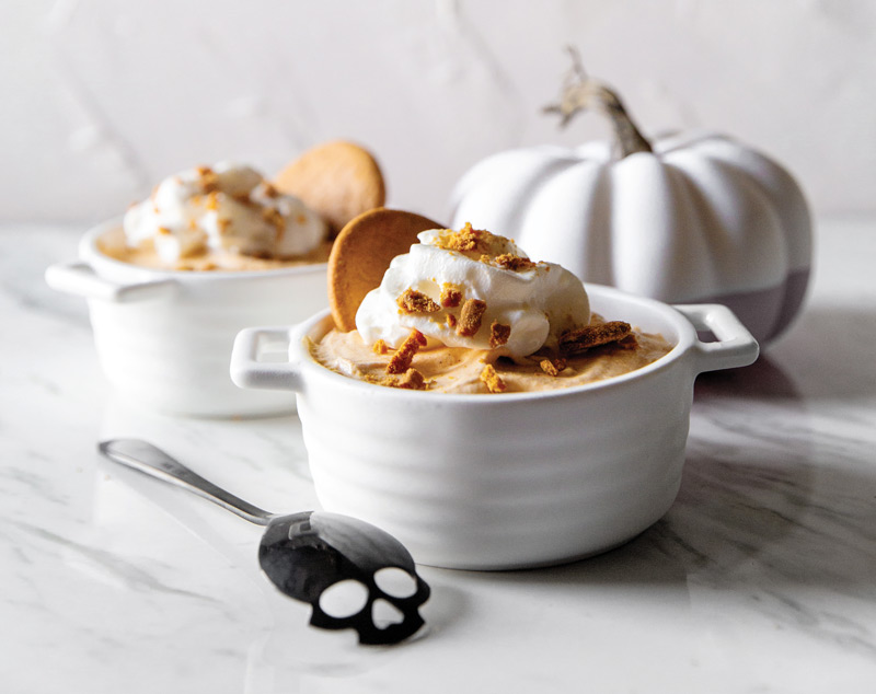 Pumpkin mousse in white bowl and white pumpkin in background