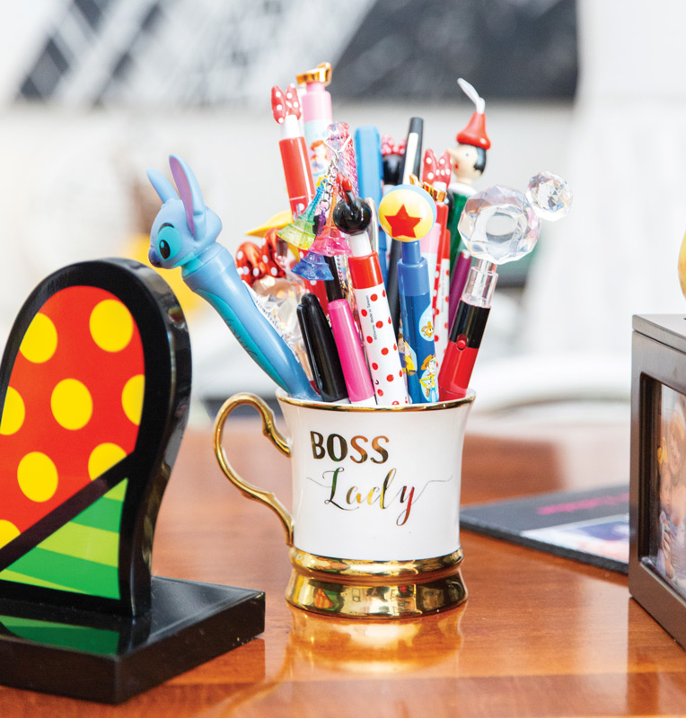 Coffee mug filled with Disney pens on Dr. Suzanne Rashidian's desk