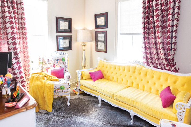 Bright yellow couch in Dr. Suzanne Rashidian's office