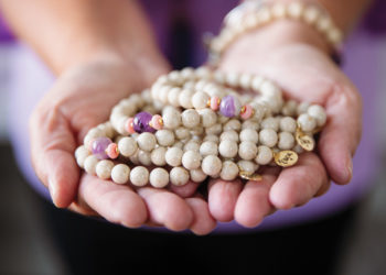 Hands holding "Erica" bracelets made by HorseFeathers Gifts