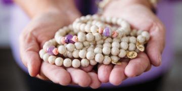 Hands holding "Erica" bracelets made by HorseFeathers Gifts