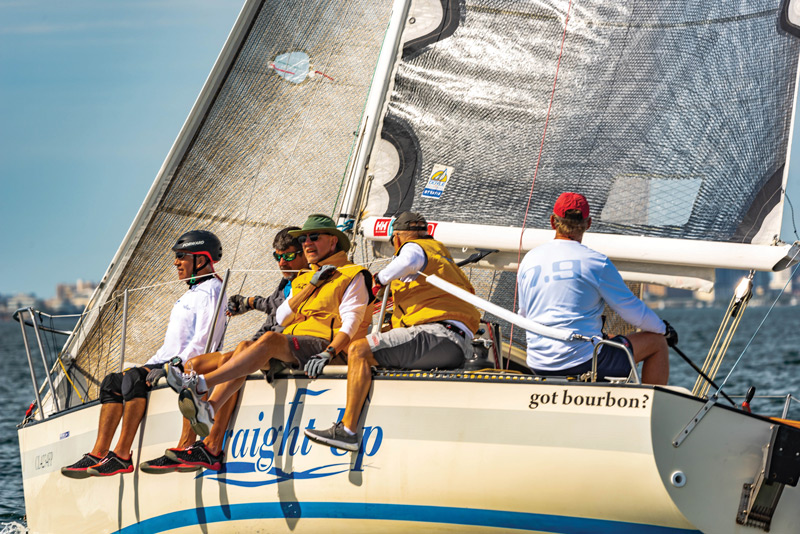 Sailing team on sailboat